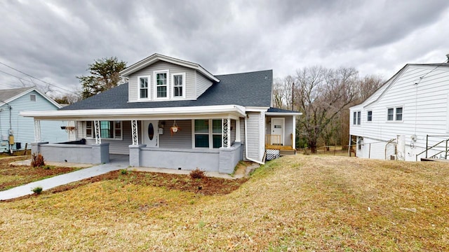 view of front of house featuring covered porch and a front yard