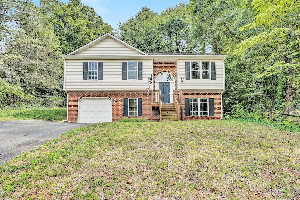 bi-level home with a front lawn and a garage