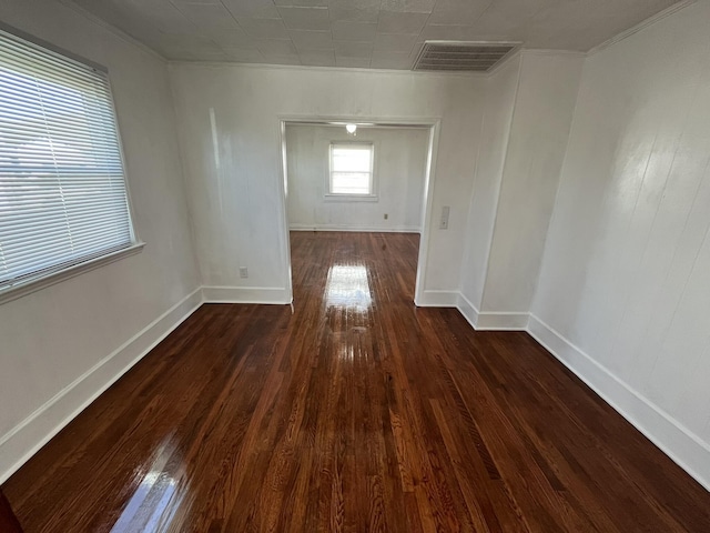 unfurnished room with crown molding and dark hardwood / wood-style floors