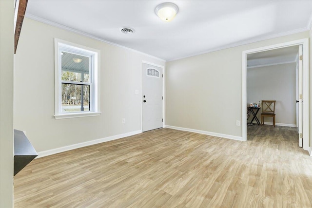 interior space with visible vents, light wood-style flooring, and crown molding