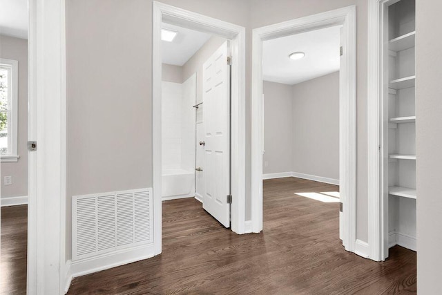 hall featuring dark hardwood / wood-style floors and built in features