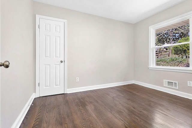 spare room with dark hardwood / wood-style floors