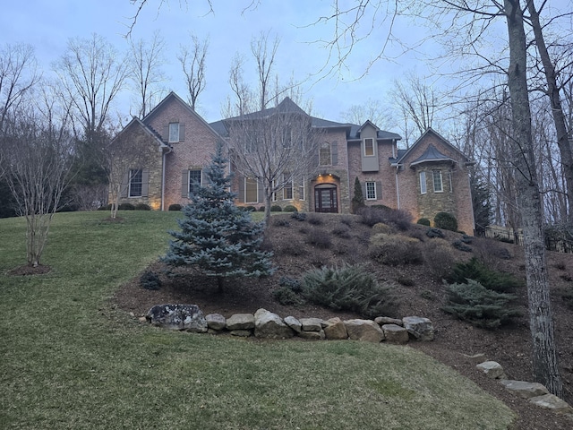 view of front of property featuring brick siding and a front yard