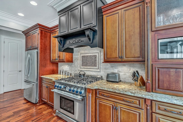 kitchen featuring light stone counters, dark wood-style floors, ornamental molding, stainless steel appliances, and backsplash