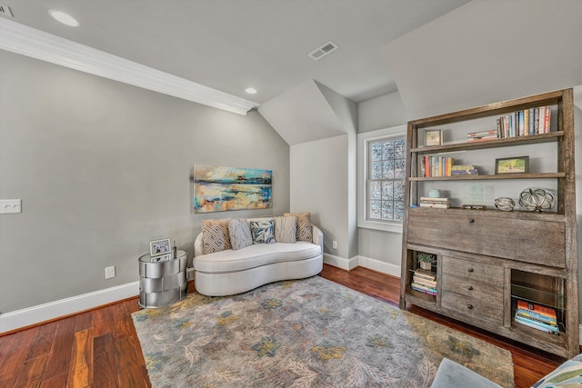 sitting room featuring visible vents, wood finished floors, baseboards, and lofted ceiling