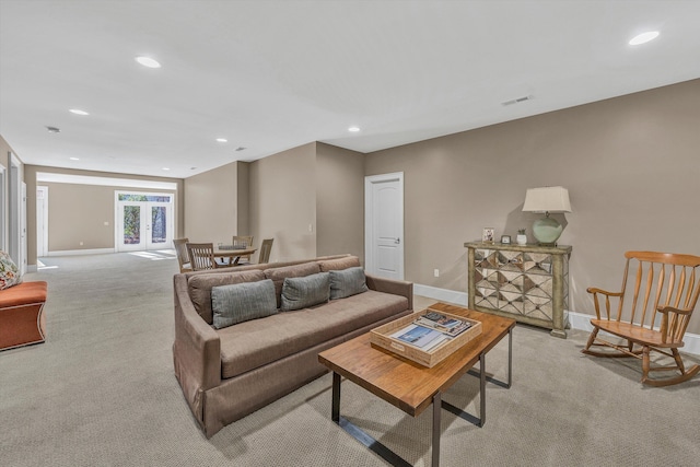 living room featuring recessed lighting, visible vents, baseboards, and light colored carpet