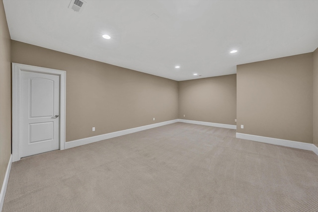 spare room featuring baseboards, recessed lighting, visible vents, and light carpet