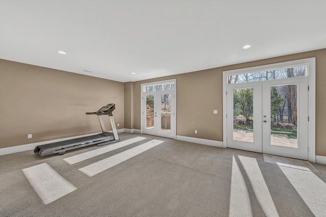 workout room featuring french doors, plenty of natural light, baseboards, and carpet flooring