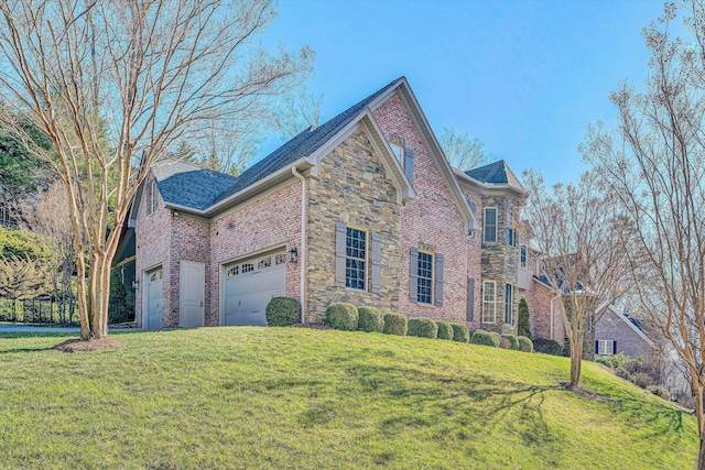 traditional-style house featuring a front yard, an attached garage, brick siding, and stone siding