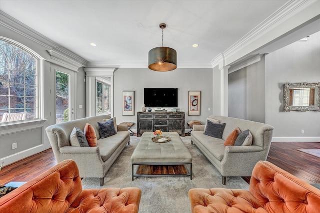 living room featuring baseboards, ornamental molding, recessed lighting, wood finished floors, and ornate columns