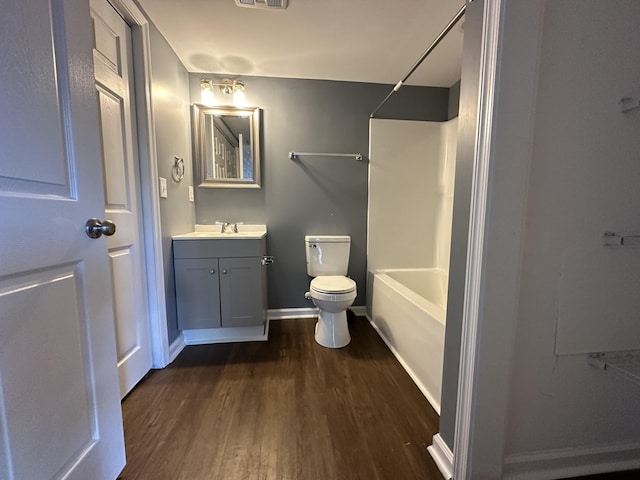 full bathroom featuring toilet, hardwood / wood-style flooring, shower / bathtub combination, and vanity