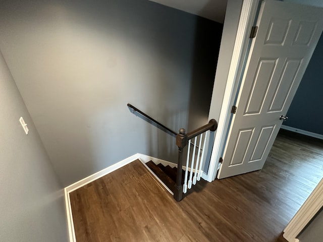 stairs featuring hardwood / wood-style flooring