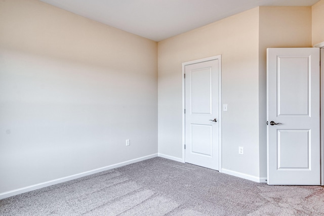 unfurnished bedroom featuring carpet flooring and baseboards