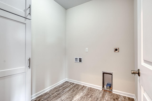 washroom with electric dryer hookup, washer hookup, baseboards, and wood finished floors