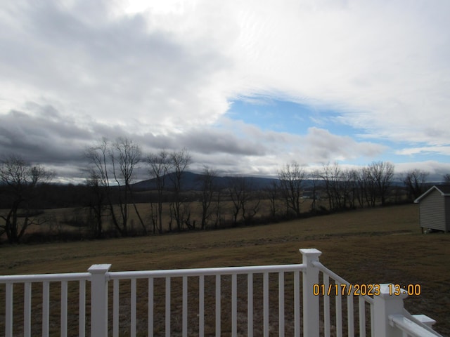 view of yard featuring a rural view and fence