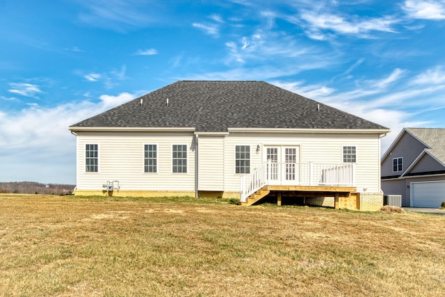 rear view of property with a yard, central AC, a wooden deck, and a shingled roof