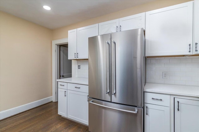 kitchen featuring light countertops, dark wood-style flooring, white cabinets, and high quality fridge