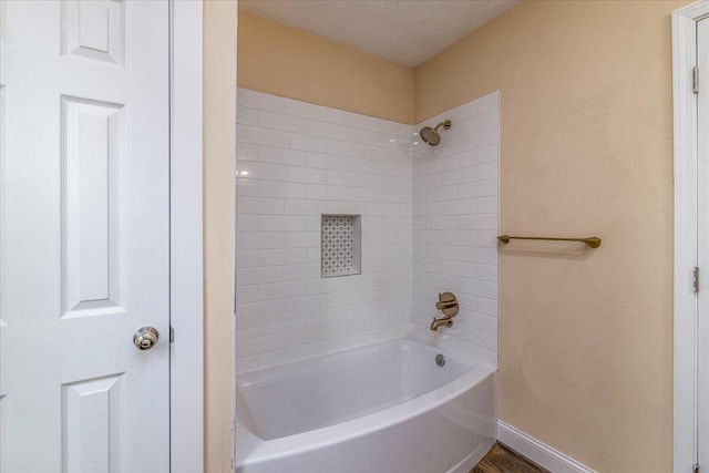 full bathroom with baseboards and shower / bathtub combination