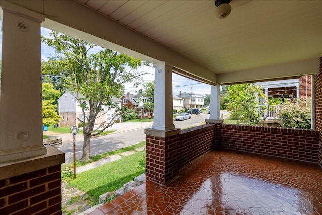 view of patio with covered porch and a residential view