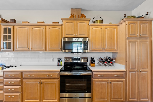 kitchen featuring stainless steel appliances and tasteful backsplash