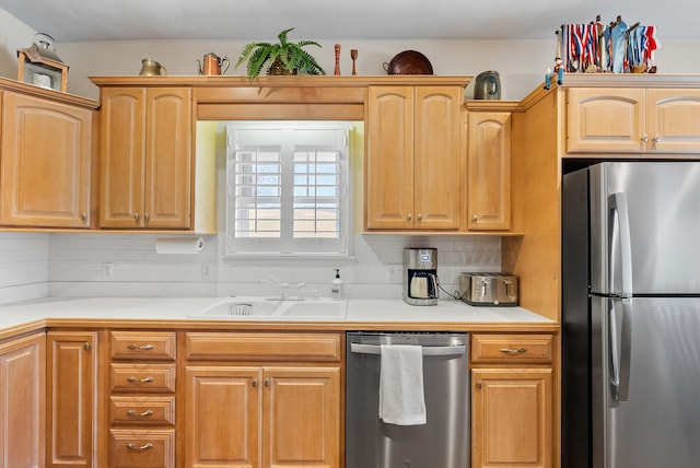 kitchen featuring sink, backsplash, and appliances with stainless steel finishes