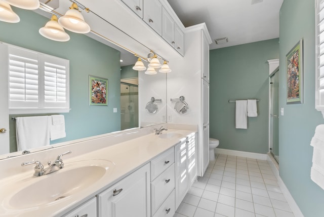 bathroom with vanity, toilet, a shower with shower door, and tile patterned floors