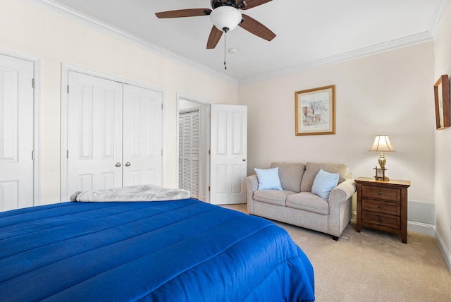 carpeted bedroom featuring a closet, ceiling fan, and ornamental molding