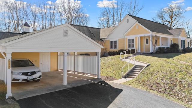 view of front of home featuring a front lawn and a carport