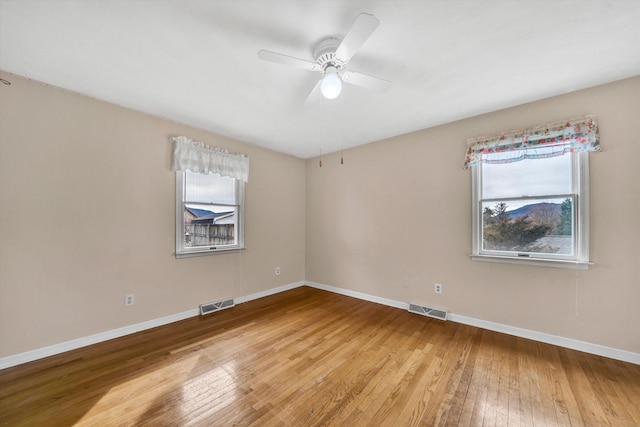 empty room with visible vents, baseboards, and light wood-style flooring