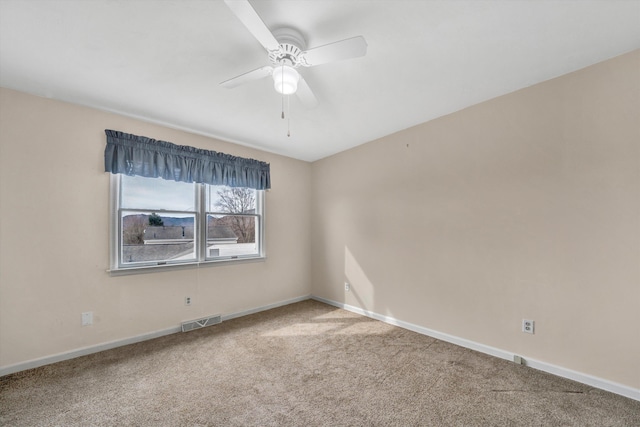 unfurnished room with visible vents, ceiling fan, baseboards, and carpet floors