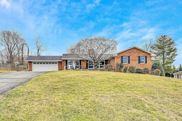 ranch-style house featuring brick siding, driveway, an attached garage, and fence