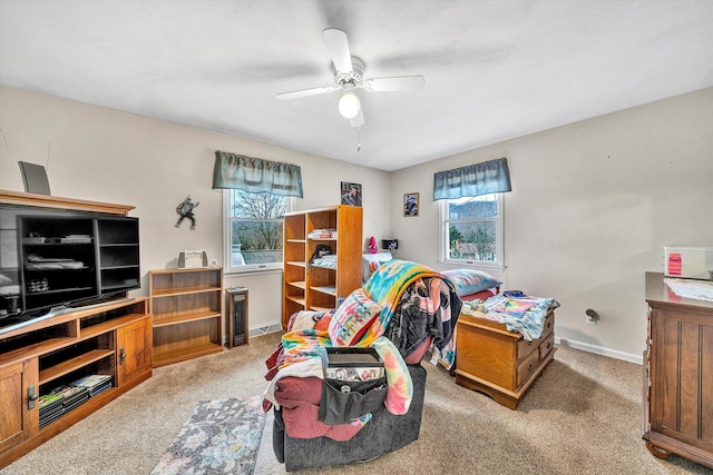 carpeted bedroom with a ceiling fan and baseboards