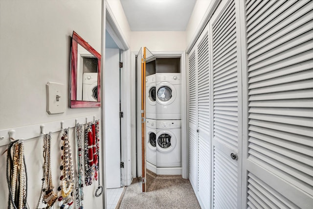 laundry room with laundry area, carpet, and stacked washing maching and dryer