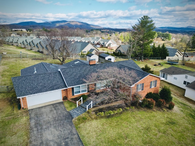 birds eye view of property with a mountain view and a residential view