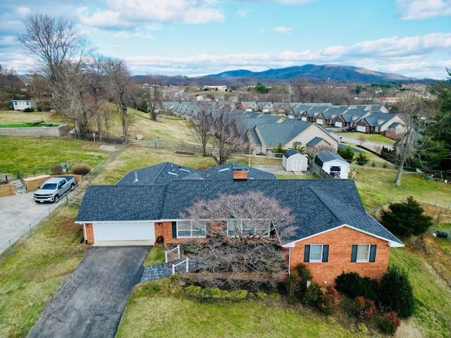 birds eye view of property with a mountain view and a residential view