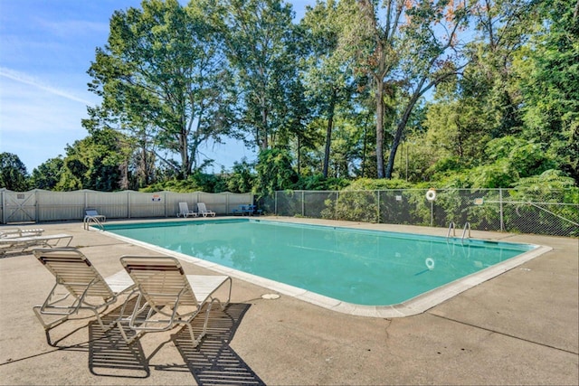 pool with fence and a patio area