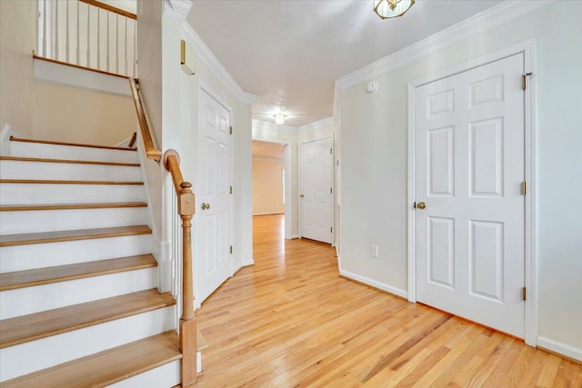 stairs with crown molding and hardwood / wood-style floors