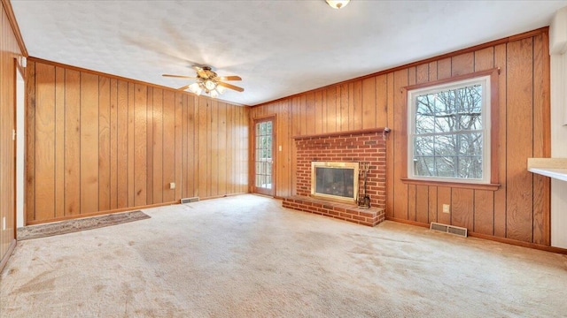 unfurnished living room with baseboards, a fireplace, visible vents, and light colored carpet