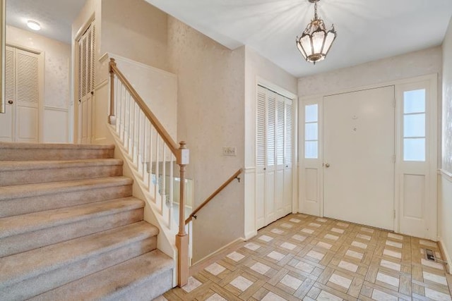 entryway featuring light floors and stairs