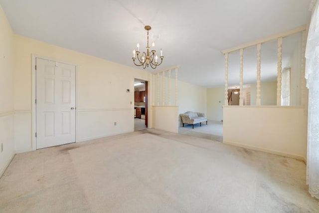 carpeted spare room featuring a chandelier