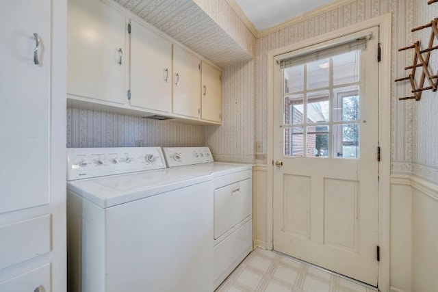 washroom featuring cabinet space, light floors, washer and dryer, and wallpapered walls