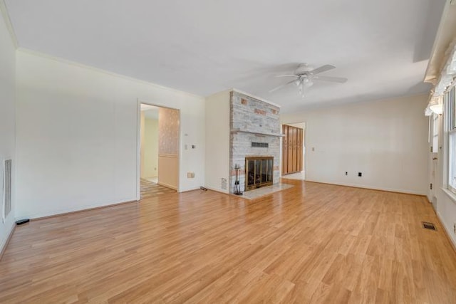 unfurnished living room with ceiling fan, light wood-style floors, visible vents, and a large fireplace