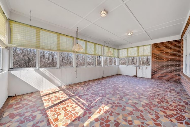 unfurnished sunroom featuring a healthy amount of sunlight