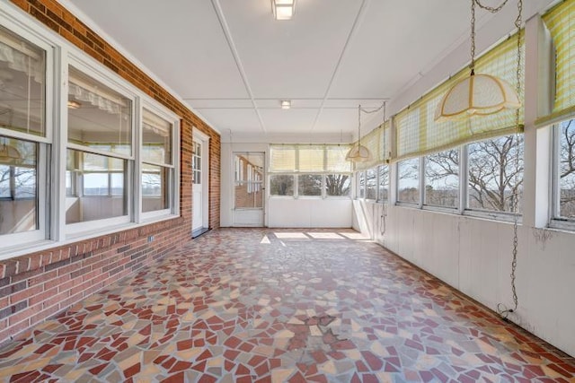 unfurnished sunroom featuring a wealth of natural light