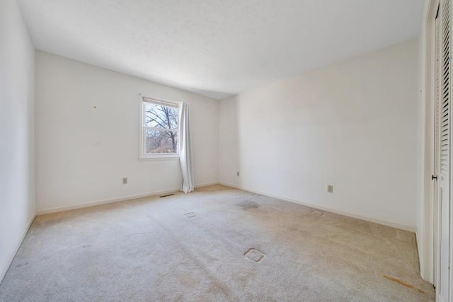 unfurnished bedroom with visible vents, baseboards, and carpet floors