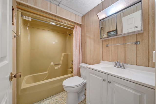 bathroom featuring vanity, wooden walls, shower / tub combo with curtain, and toilet