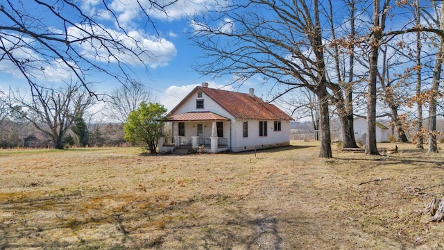 view of front of home with covered porch and a chimney