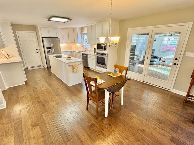 dining space with light wood finished floors and a chandelier