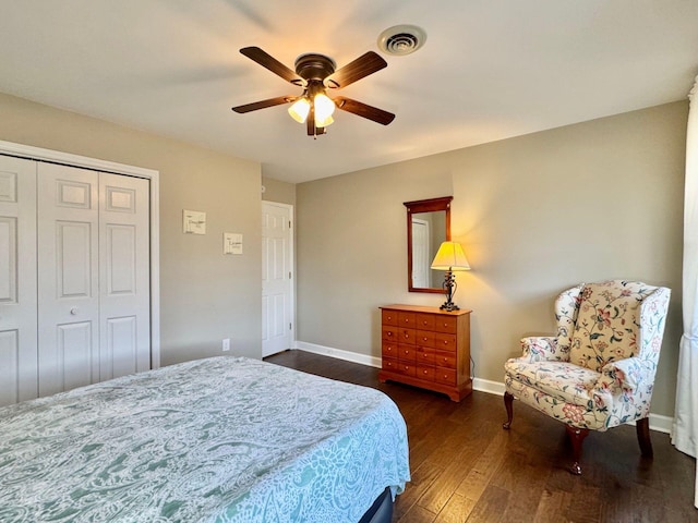 bedroom featuring a ceiling fan, visible vents, baseboards, a closet, and dark wood-style floors