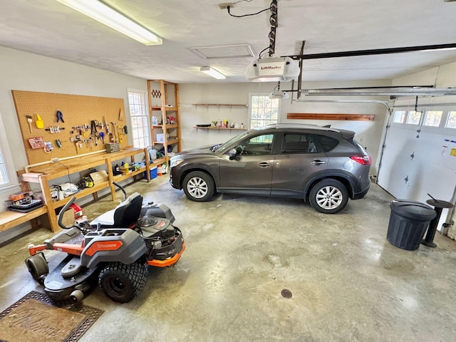 garage featuring a garage door opener and a workshop area